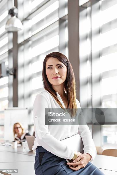 Attractive Businesswoman In An Office Holding A Digital Tablet Stock Photo - Download Image Now