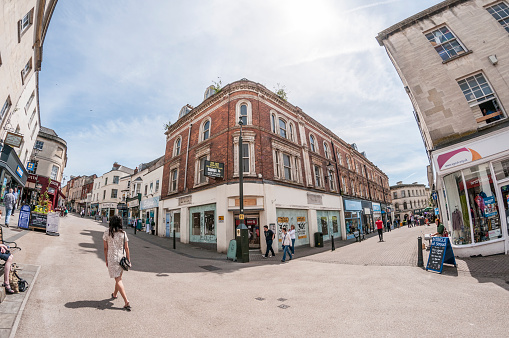 Stroud, United Kingdom - June 18, 2015: Pedestrians shopping on a busy city street in Stroud, England. Photograph shot with a fisheye lens.