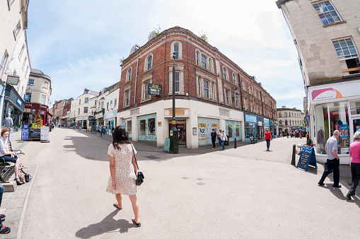 Stroud, United Kingdom - June 18, 2015: Pedestrians shopping on a busy city street in Stroud, England. Photograph shot with a fisheye lens.