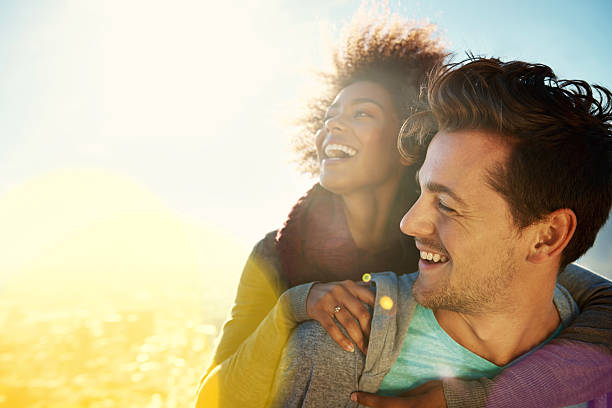 Delightful dalliances Shot of a young couple spending time together in the outdoors black man white woman couple stock pictures, royalty-free photos & images