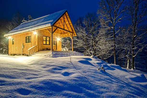istock Rustic cabin in winter blizzard snowstorm at night 481915019