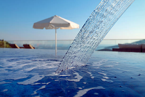 Flowing spa faucet,Hotel Spa image. Outdoor Hotel pool and waterfall.