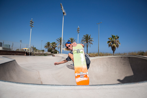 Skateboarder jumping in skatepark