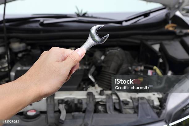 Hand With Wrench On Car Engine Stock Photo - Download Image Now - 2015, Blue, Car