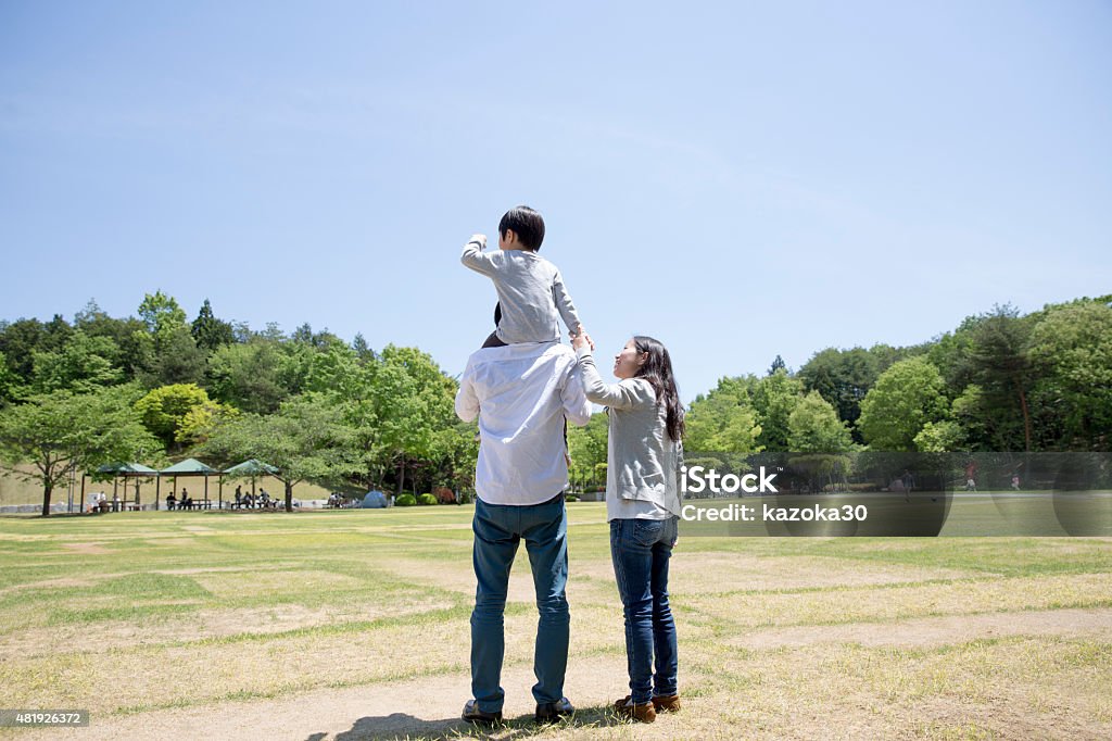 Piggyback Japanese family in the park Rear View Stock Photo