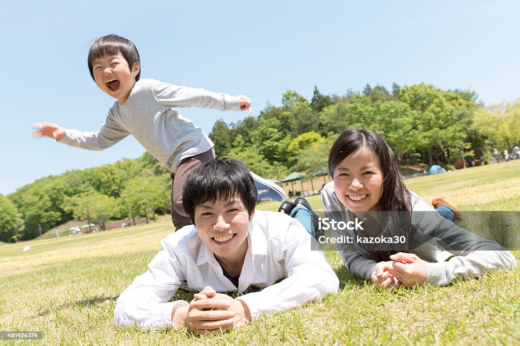 Family holiday Japanese family playing in the park Child Stock Photo