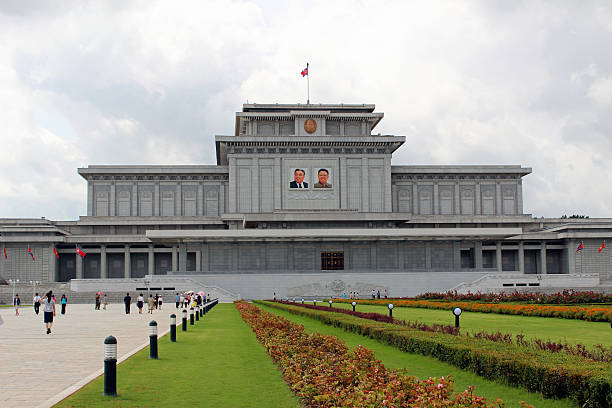 North Korea DPRK: Kumsusan Memorial Palace Of The Sun Pyongyang, North Korea - August 14, 2013: Visitors make their way to the entrance of the Kumsusan Memorial Palace Of The Sun (mausoleum of Kim Il Sung and Kim Jong Il). A palatial structure where the two leaders lay in state, and each has a museum dedicated to them. kim il sung mausoleum stock pictures, royalty-free photos & images