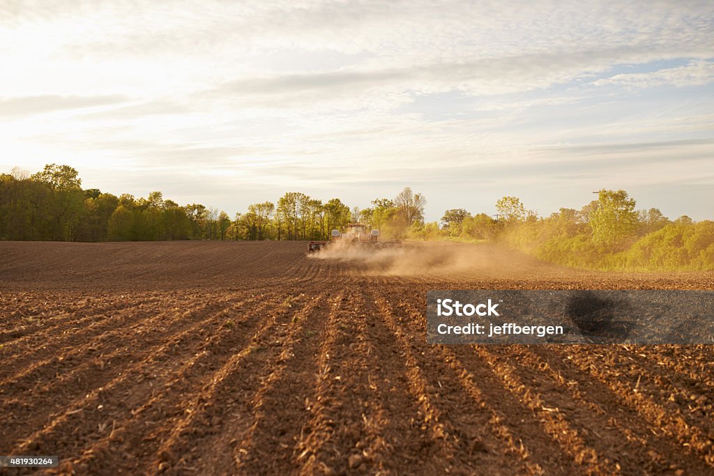 In the heartland Shot of a tractor pulling a seeder over a plowed field in the late afternoonhttp://195.154.178.81/DATA/i_collage/pu/shoots/805333.jpg 2015 Stock Photo