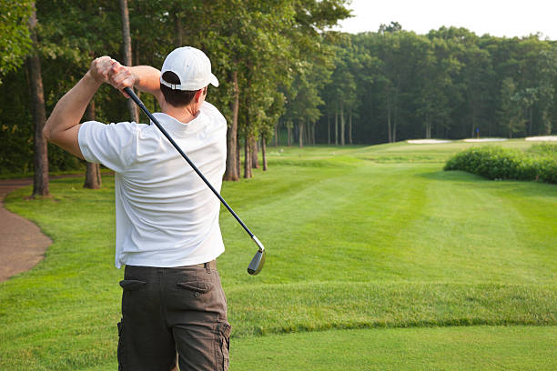 istock Young male golfer tees off on a par three 481930496