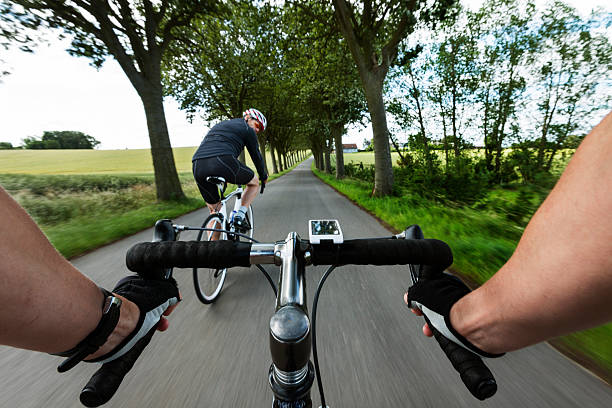 Cyclist sprinting past desert hills on a hot summers day.