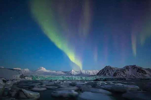 Arctic winter in south Spitsbergen. Aurora borealis over arctic fiord.