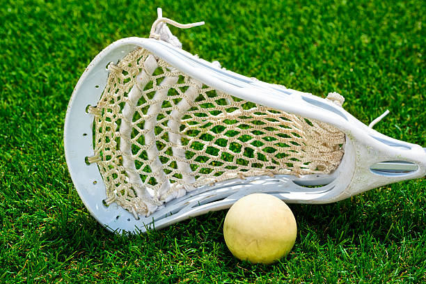 istock White ball and white Lacrosse stick on artificial turf 481933838
