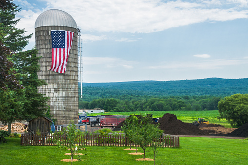 A large American flag hangs from a silo on a farm in Central Massachusetts.