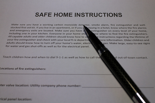 Family compiling a Safe Home Instructions Plan in case of natural disasters and other emergencies.