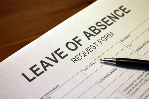 Someone filling out Leave of Absence Request Form.