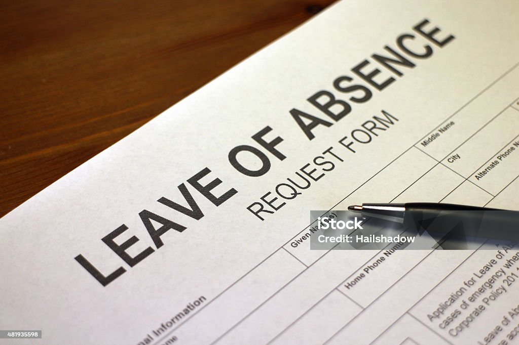 Leave of Absence Request Form Someone filling out Leave of Absence Request Form. Leaving Stock Photo