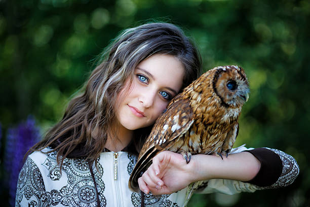 istock Beautiful young girl with owl 481936144