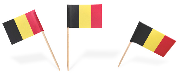 Small cocktail flags of Belgium in different positions isolated on white.(series) . Also easy to use as a design element :)