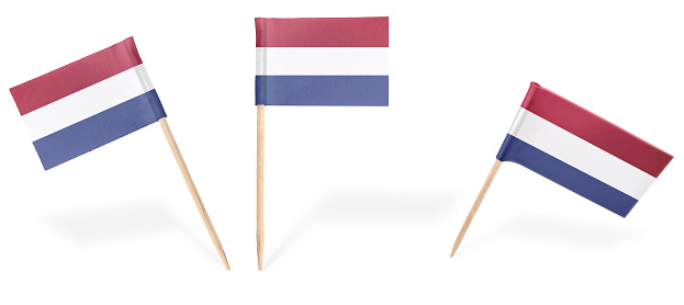 Small cocktail flags of Netherlands in different positions isolated on white.(series) . Also easy to use as a design element :)