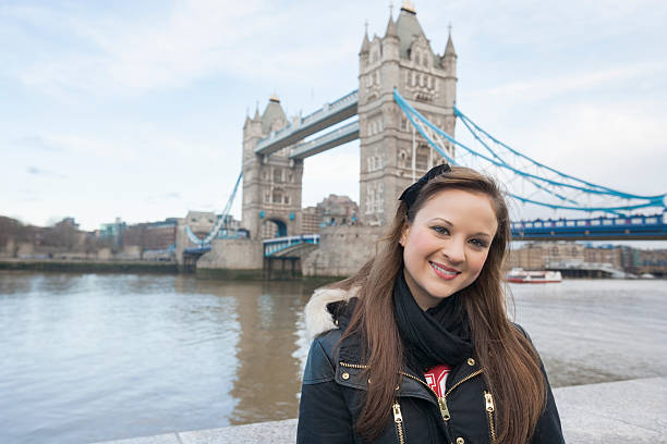 istock Beautiful young woman standing in front of tower bridge 481945577