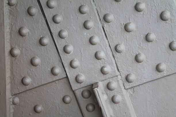 istock Heavily painted rivet heads background 481945888