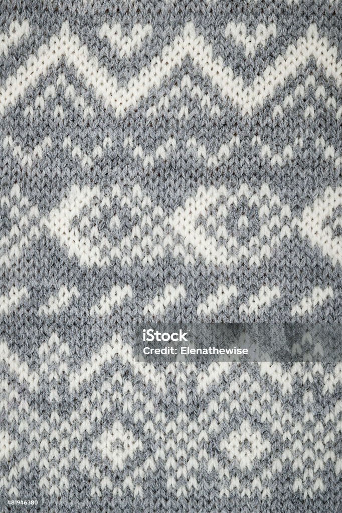 Knit fabric background Closeup of knit fabric background with knitted grey and white geometric pattern 2015 Stock Photo