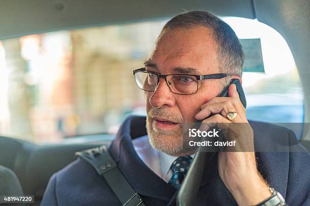 Well Dressed Senior Man On Phone In London Taxi Stock Photo - Download Image Now - 2015, Active Seniors, Adult