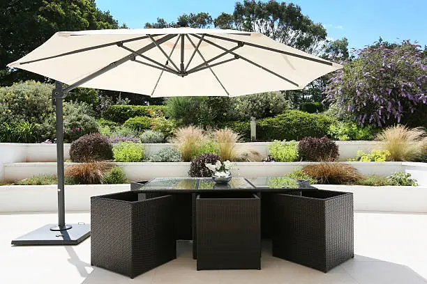 Table and chairs set out on the terrace in the sun. 