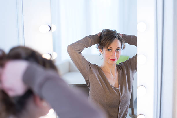 istock cheerful young women adjusting her make-up 481949385