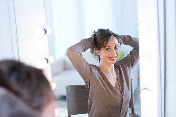 istock cheerful young women adjusting her make-up 481949389