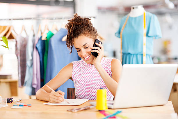 istock Fashion Designer Answering Smart Phone While Sketching In Workshop 481949554
