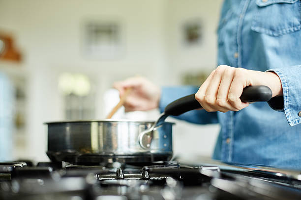 istock Woman stirring food in cooking pan in kitchen 481949604