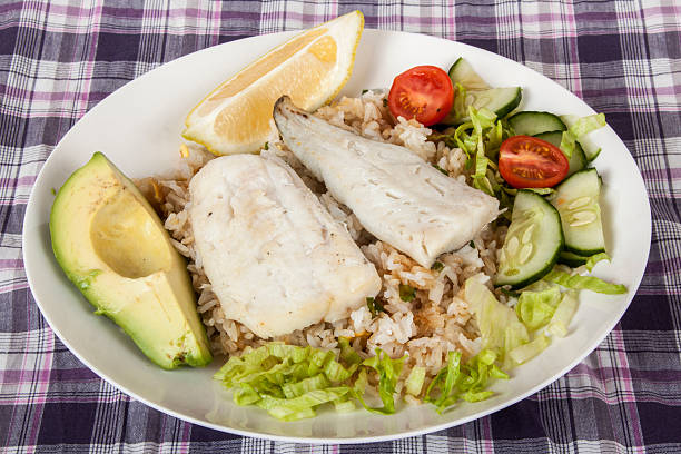 istock Hake on Fried Jasmine Rice with Lemon, Avocado and Salad 481951068