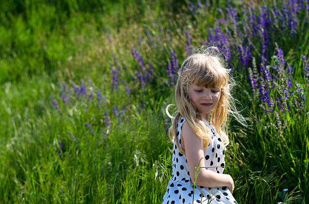istock beautiful blond girl in meadow 481956420