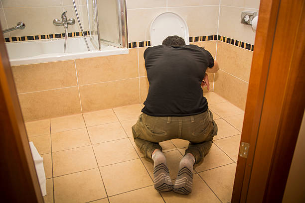 istock Drunk Young Man Vomiting in the Toilet at Home 481959024
