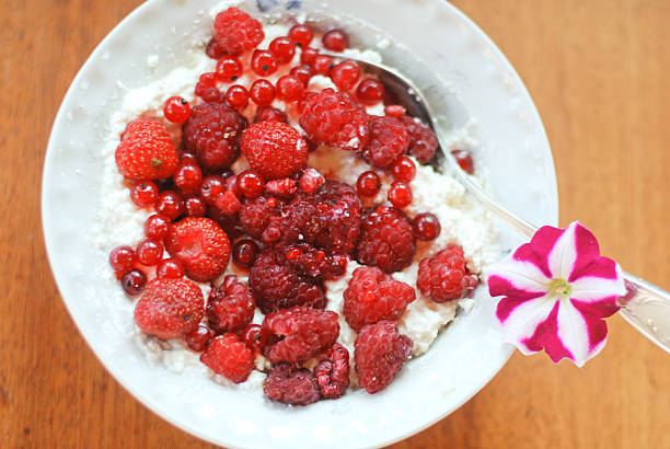 Fresh berries with cream cheese in a bowl stock photo