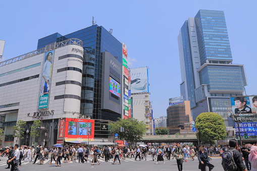Tokyo Japan - May 8, 2015: People cross busy Shibuya crossing in Shibuya Tokyo Japan.