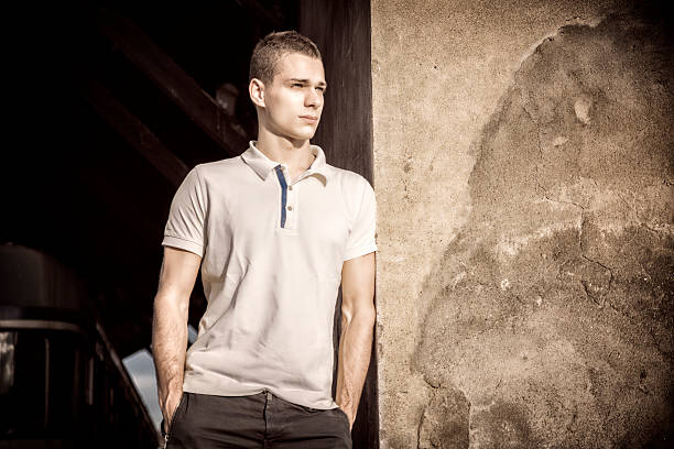 Portrait of attractive young man in a white shirt outdoors
