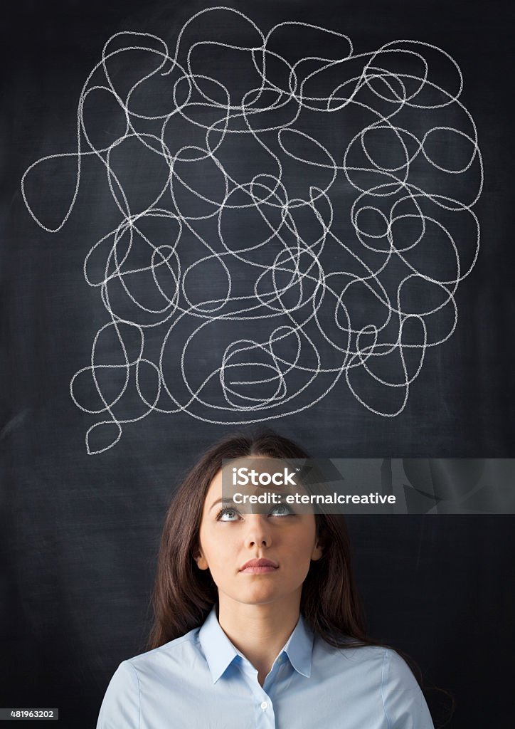 Businesswoman Mess on Blackboard Portrait of confused businesswoman on blackboard Business Stock Photo