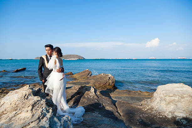 istock Couple standing on the rocks by the sea. 481963328