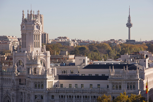 Madrid, Spain - 26th April 2022. Elevated view of part of central Madrid with part of the Palace of Cibeles left front, and behind it, the Paseo de Recoletos. The Torres de Colon, under refurbishment, are top right.