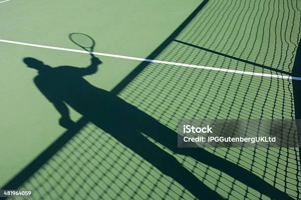 Shadow Of Senior Man Playing Tennis On Court Stock Photo - Download Image Now - 60-69 Years, 65-69 Years, Active Lifestyle