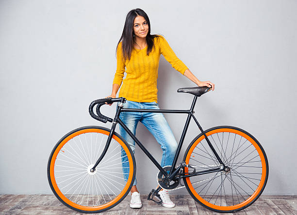 istock Happy woman standing near bicycle 481964078