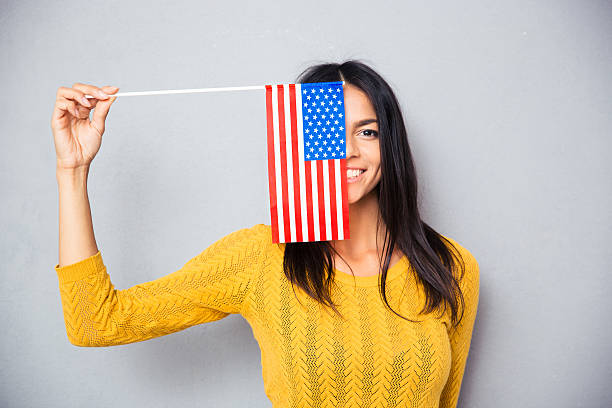 istock Woman covering her face with american flag 481967934