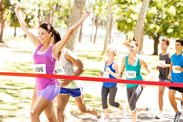 istock Female Marathon Runner Crossing Finish Line 481968866