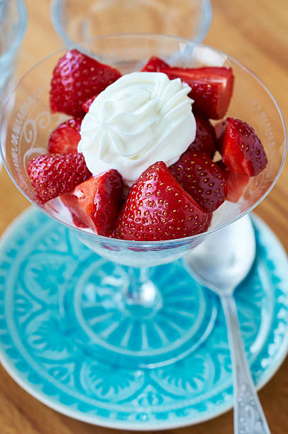 istock Strawberries with cream in goblet on blue plate 481968990