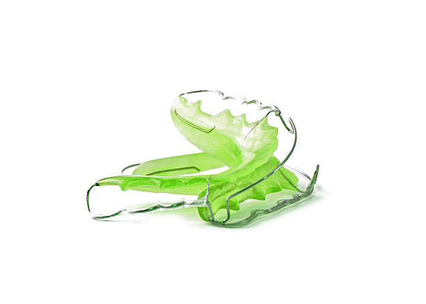 Green dental retainer orthodontia, isolated on white background Green dental retainer orthodontia, isolated on white background detachable stock pictures, royalty-free photos & images