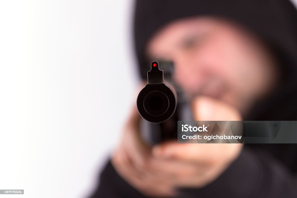 Man shooting,selective focus Man shooting at a target, focus on gun. 2015 Stock Photo