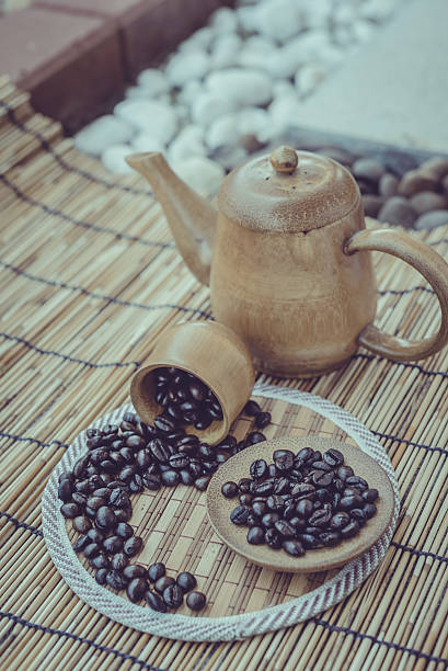 istock Coffee beans and cup set on bamboo wooden background. 481978524
