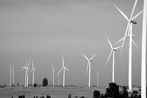 istock wind turbine against cloudy blue sky background 481978738